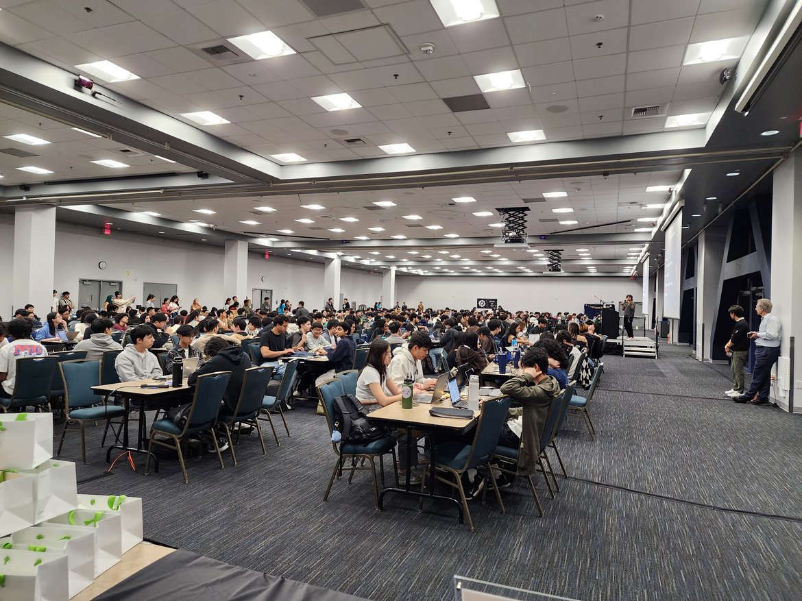 Venue room is filled with seated hackers. 